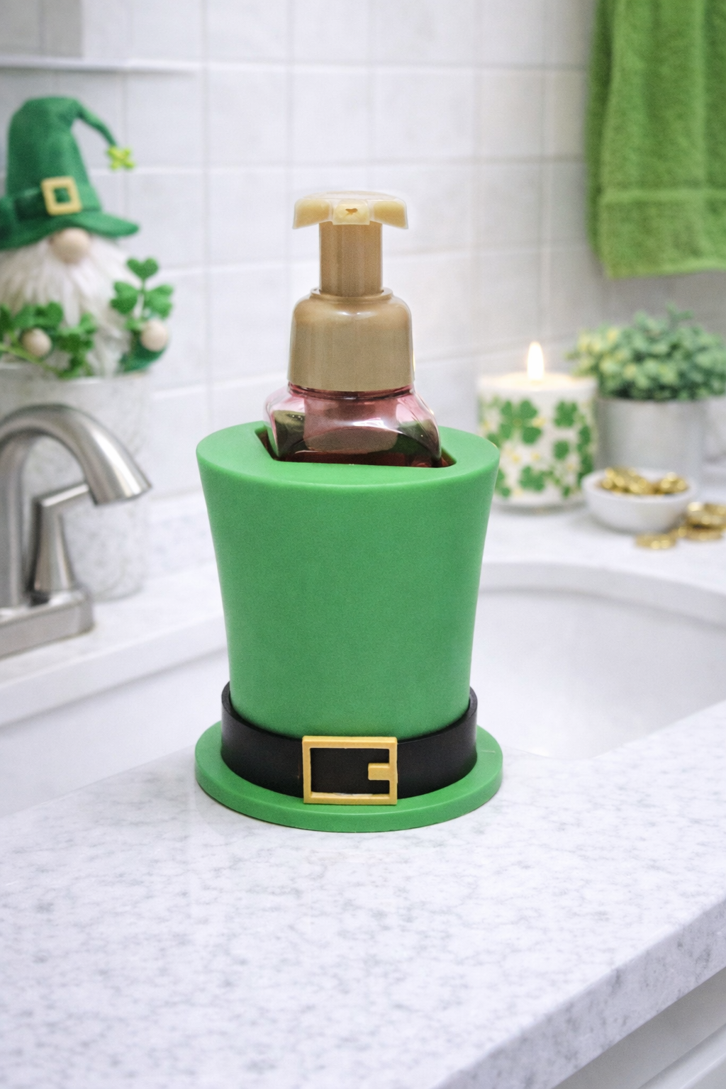 Green St. Patrick’s Day leprechaun hat foaming soap holder with black band and gold buckle displayed with a foaming soap bottle inside for festive bathroom decor