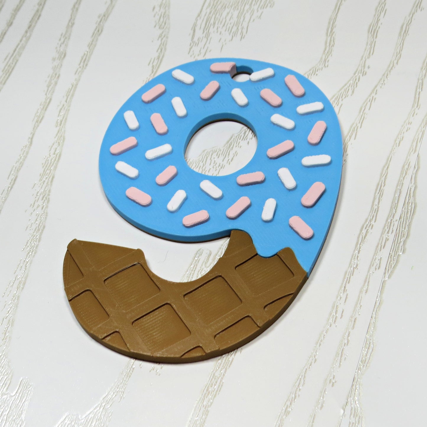 Custom 3d printed sports bag tag in drip style number with blue icing and sprinkles