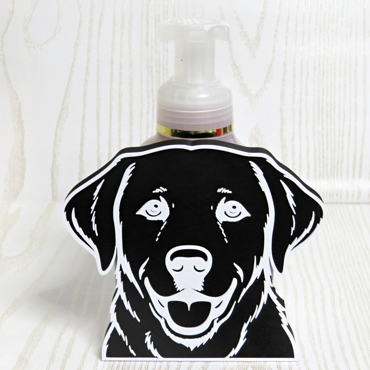 Black and white Labrador portrait foaming soap bottle holder with a soap bottle behind it