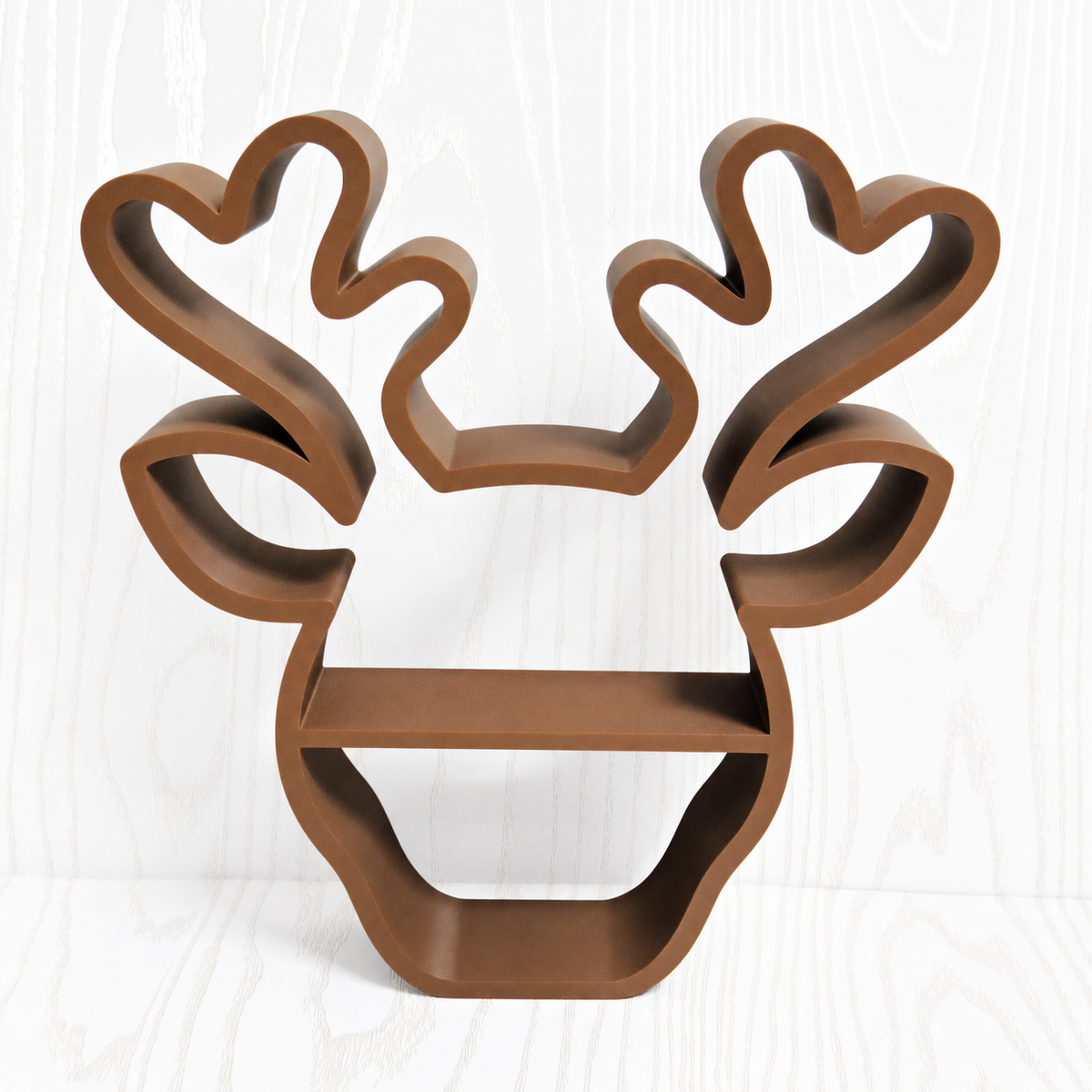 Brown reindeer head shaped freestanding display shelf with open antlers and two open levels