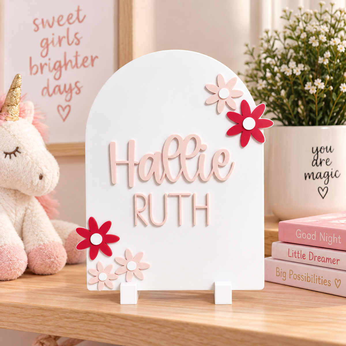 Personalized white arch sign with pink and red daisy accents, name personalized