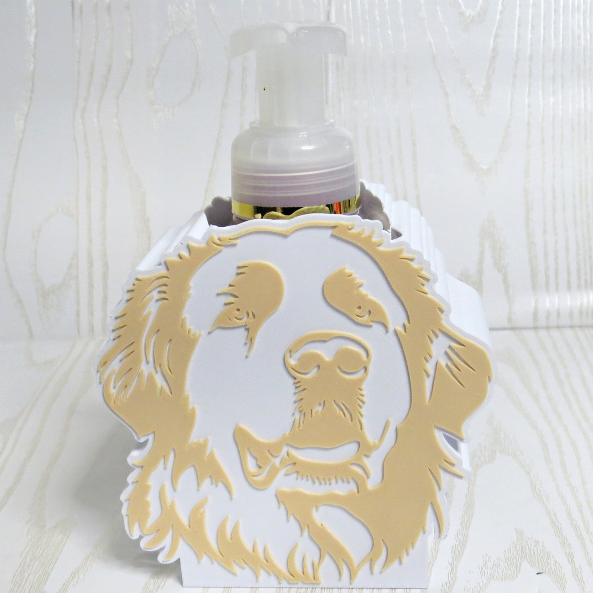 White and tan golden retriever portrait foaming soap bottle holder with a soap bottle behind it