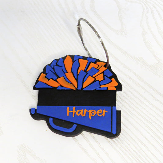 Personalized blue and orange cheerleader megaphone bag tag with hair tie holder and the name Harper