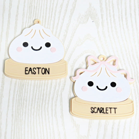Personalized dumpling Christmas ornament with custom name, one plain and one with pink bow