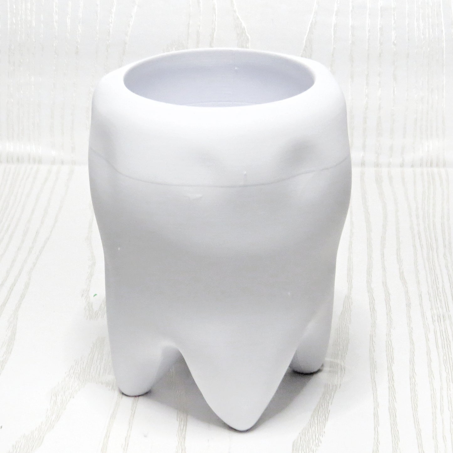 Smiling Tooth Holder - flat lay on surface
