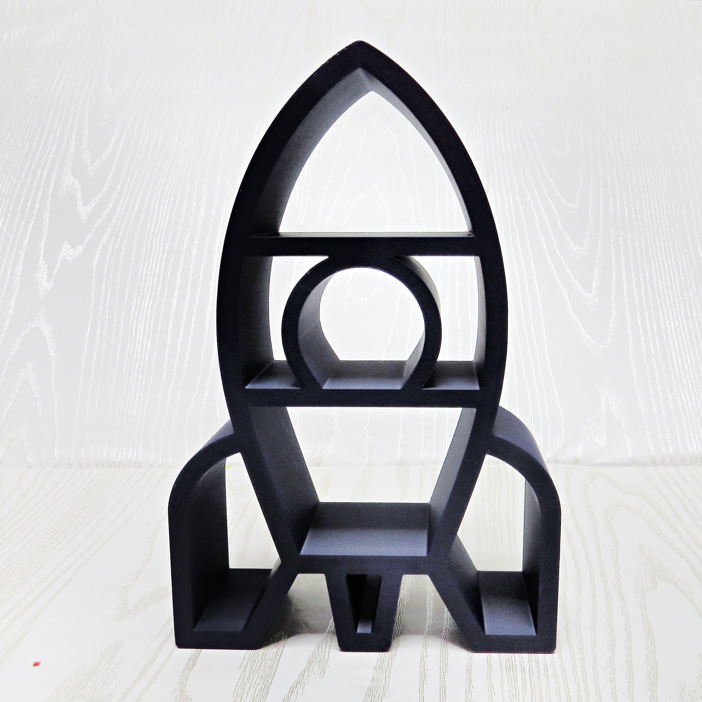 matte-black-3d-printed-rocket-ship-silhouette-three-tier-open-shelf-porthole-window-fin-legs-space-kids-room-decor