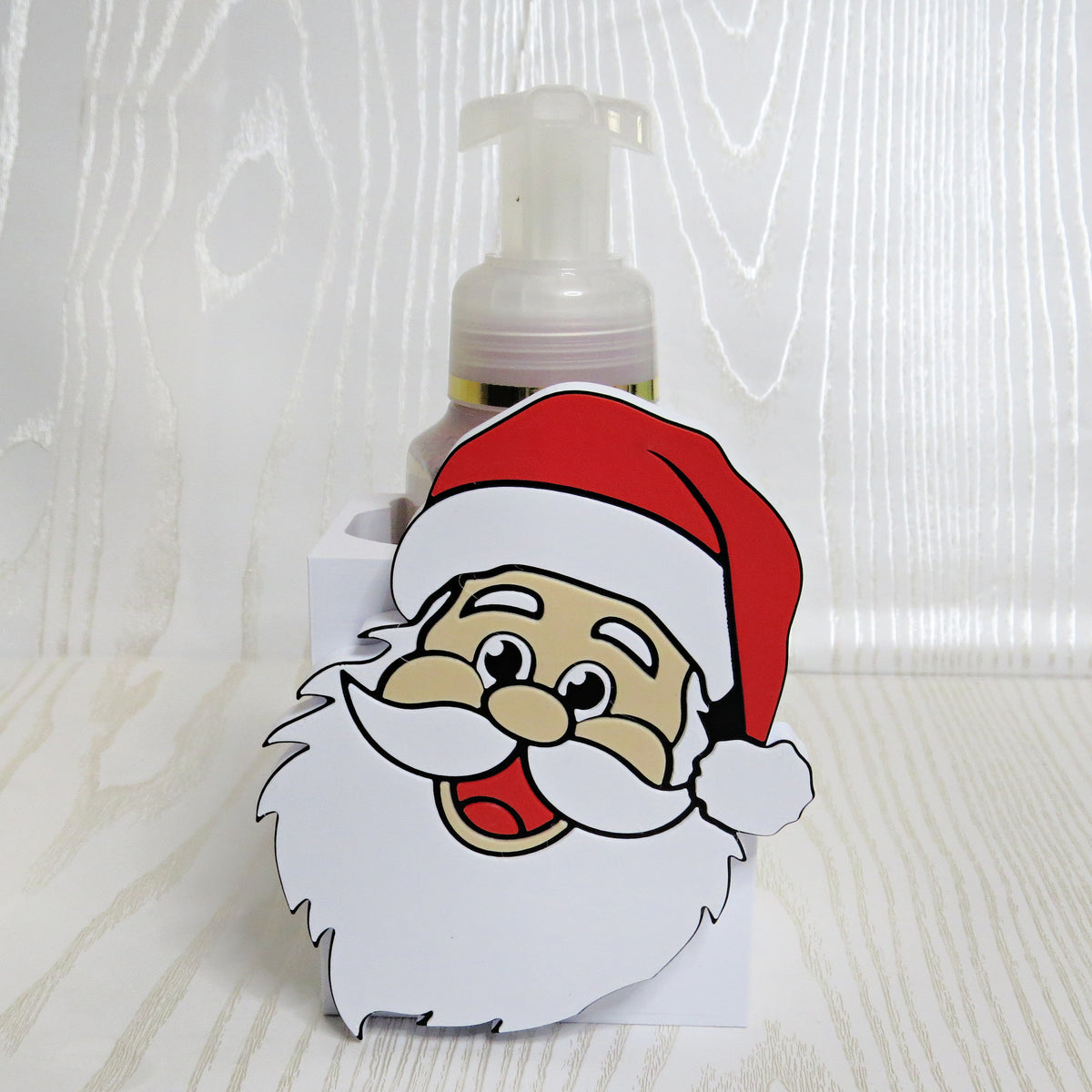 Smiling Santa face shaped foaming soap bottle holder for Christmas decor