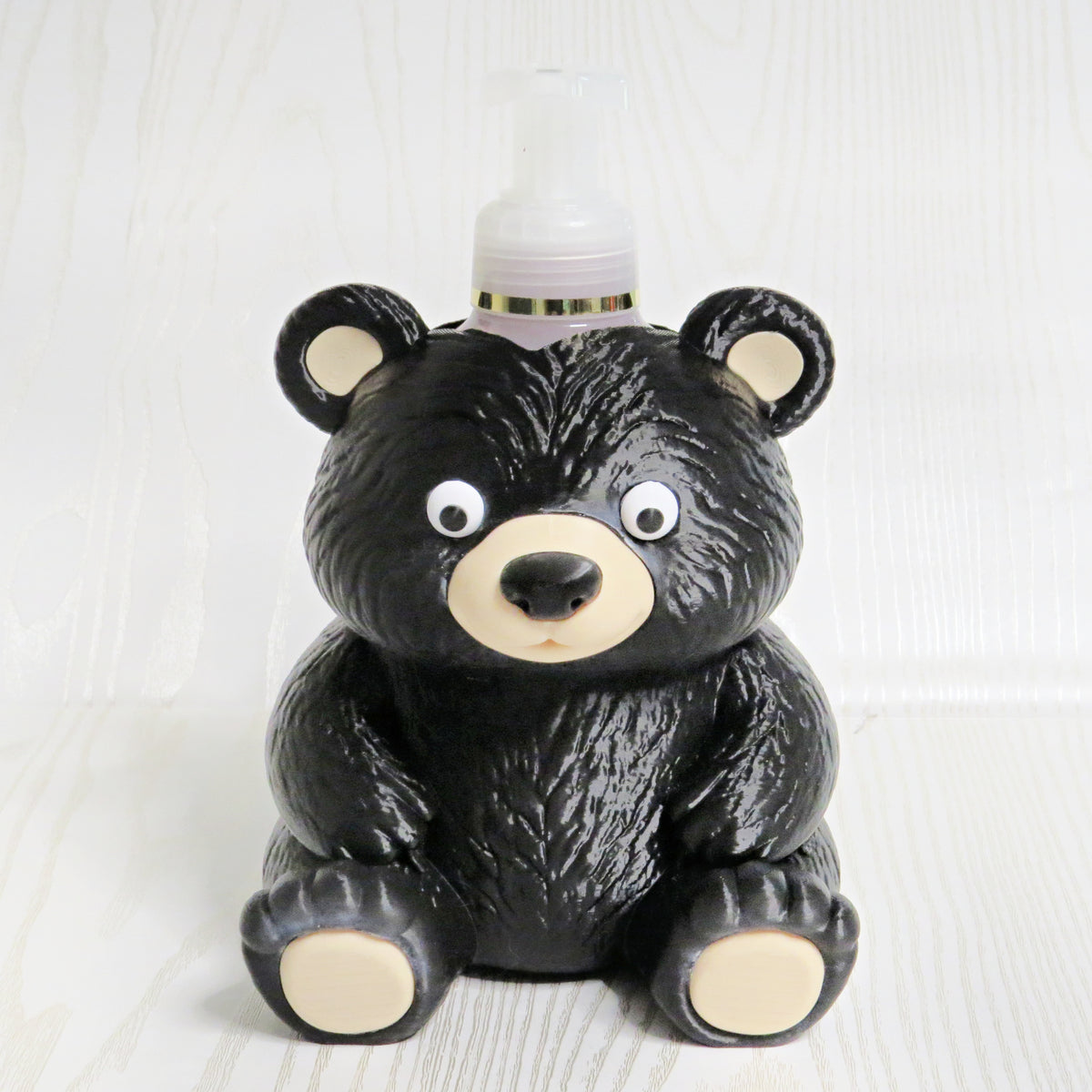 Cute black bear shaped foaming soap bottle holder with googly eyes for bathroom decor