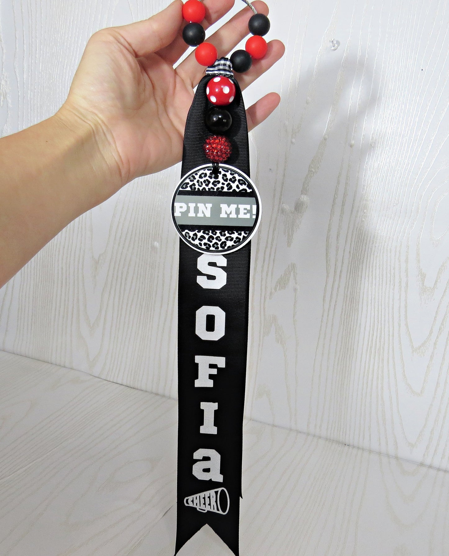Cheerleader Pin Me! Ribbon for Backpack - Cheer Bag Tag Personalized with Nam... displayed on countertop