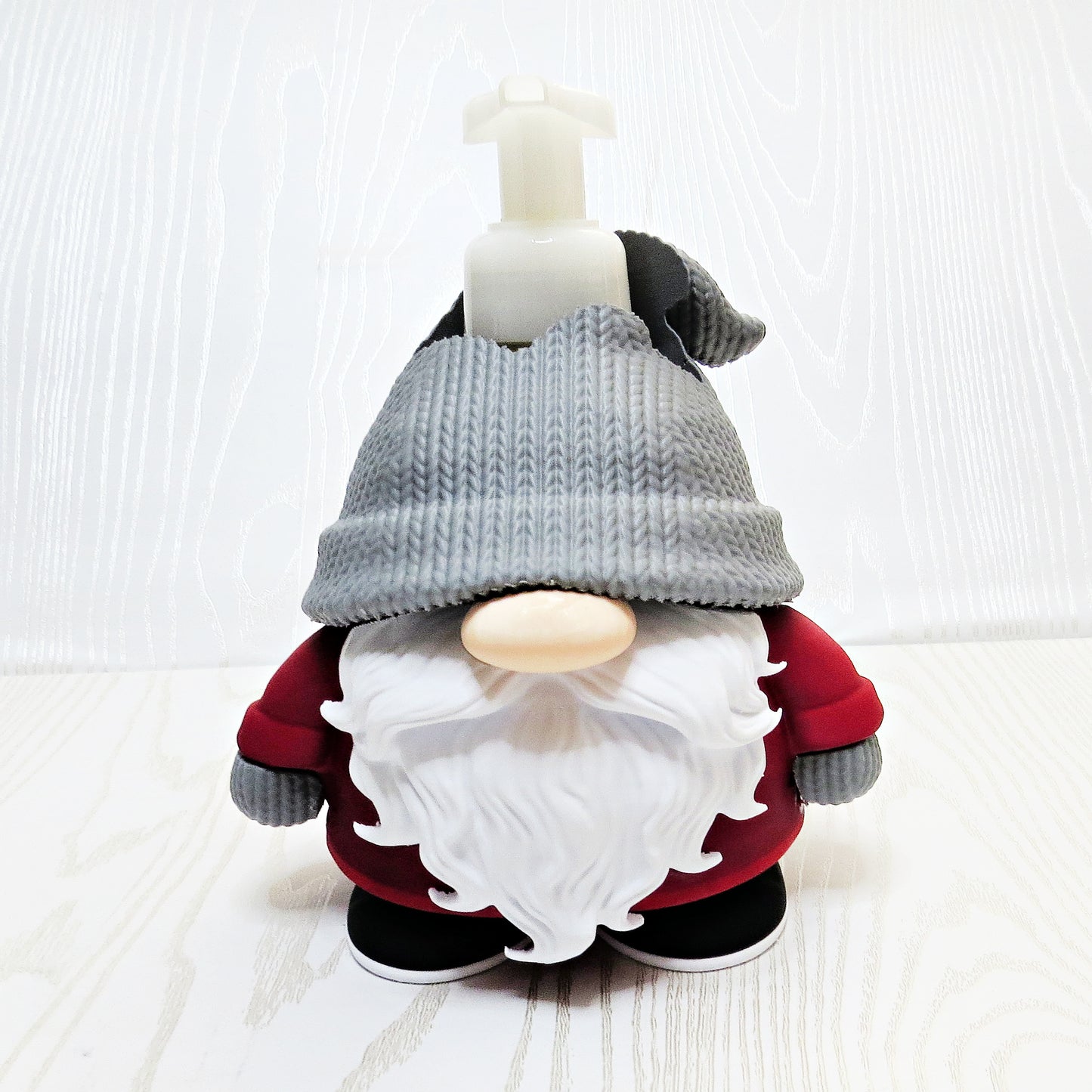 Christmas gnome foaming soap holder with red outfit and gray hat on kitchen counter