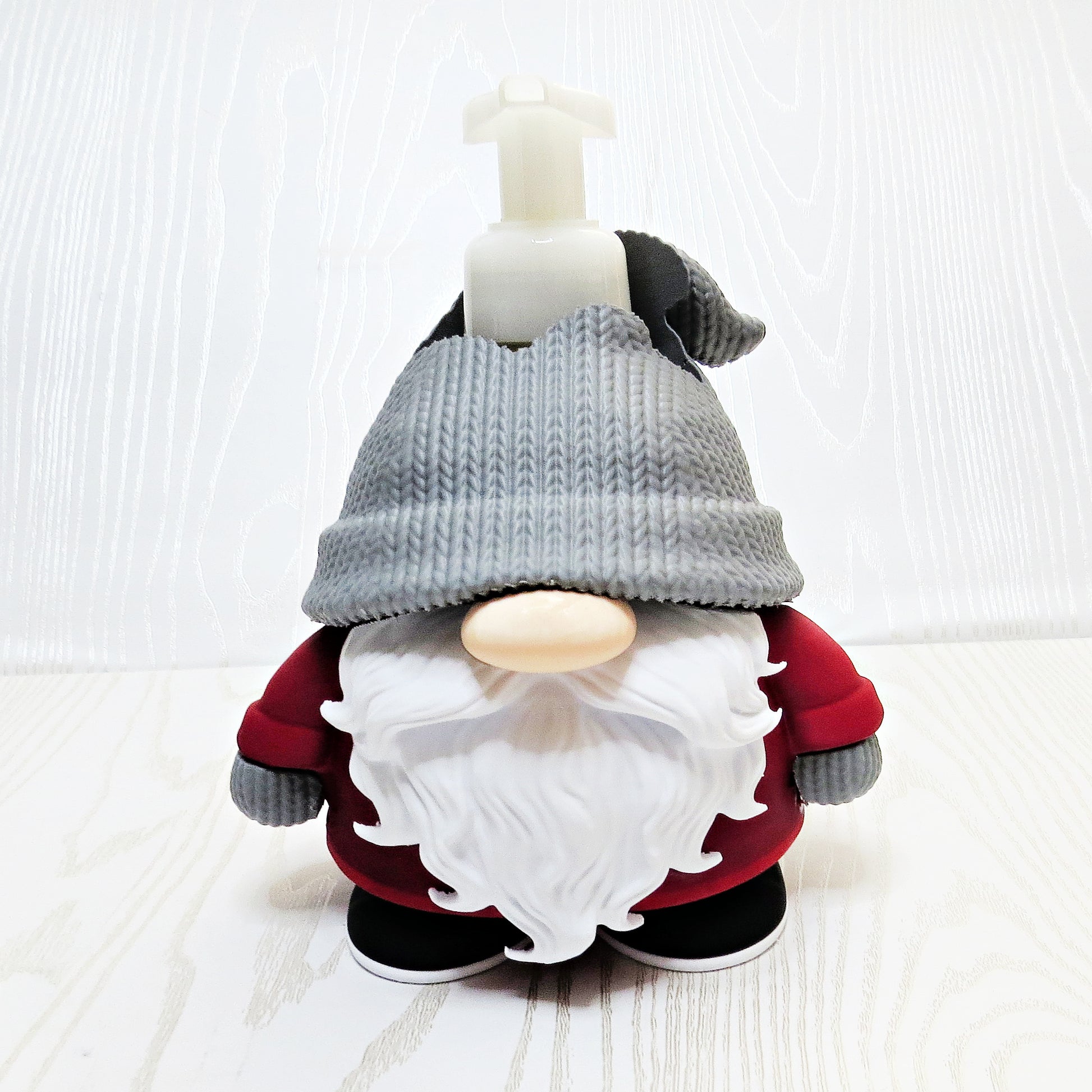 Christmas gnome foaming soap holder with red outfit and gray hat on kitchen counter
