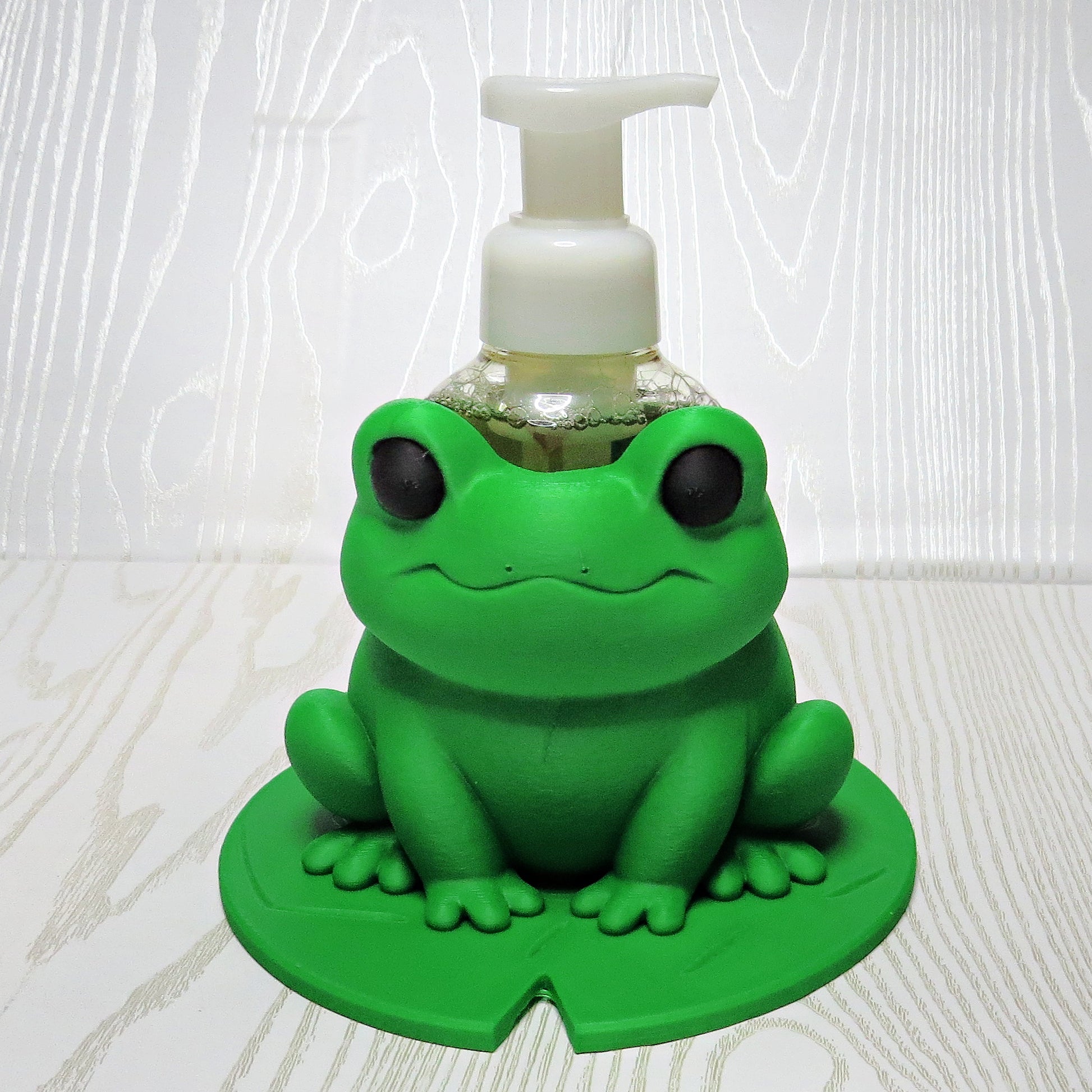 green-3d-printed-frog-foaming-soap-bottle-holder-sitting-on-lily-pad-base-bathroom-decor