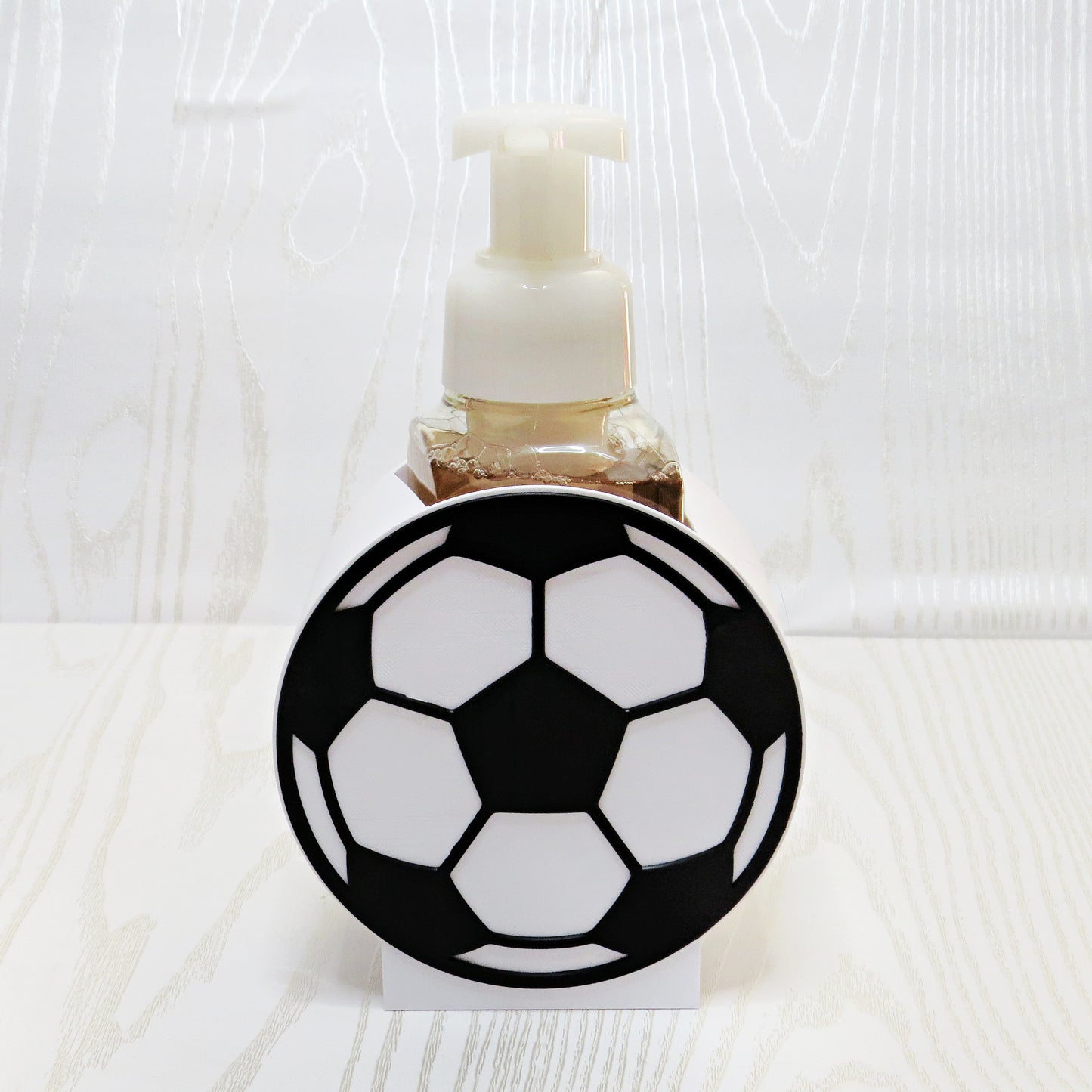 Soccer Ball Foaming Soap Holder - Sports Bathroom Decor for Kids & Soccer Fans - lifestyle with soap bottle inserted