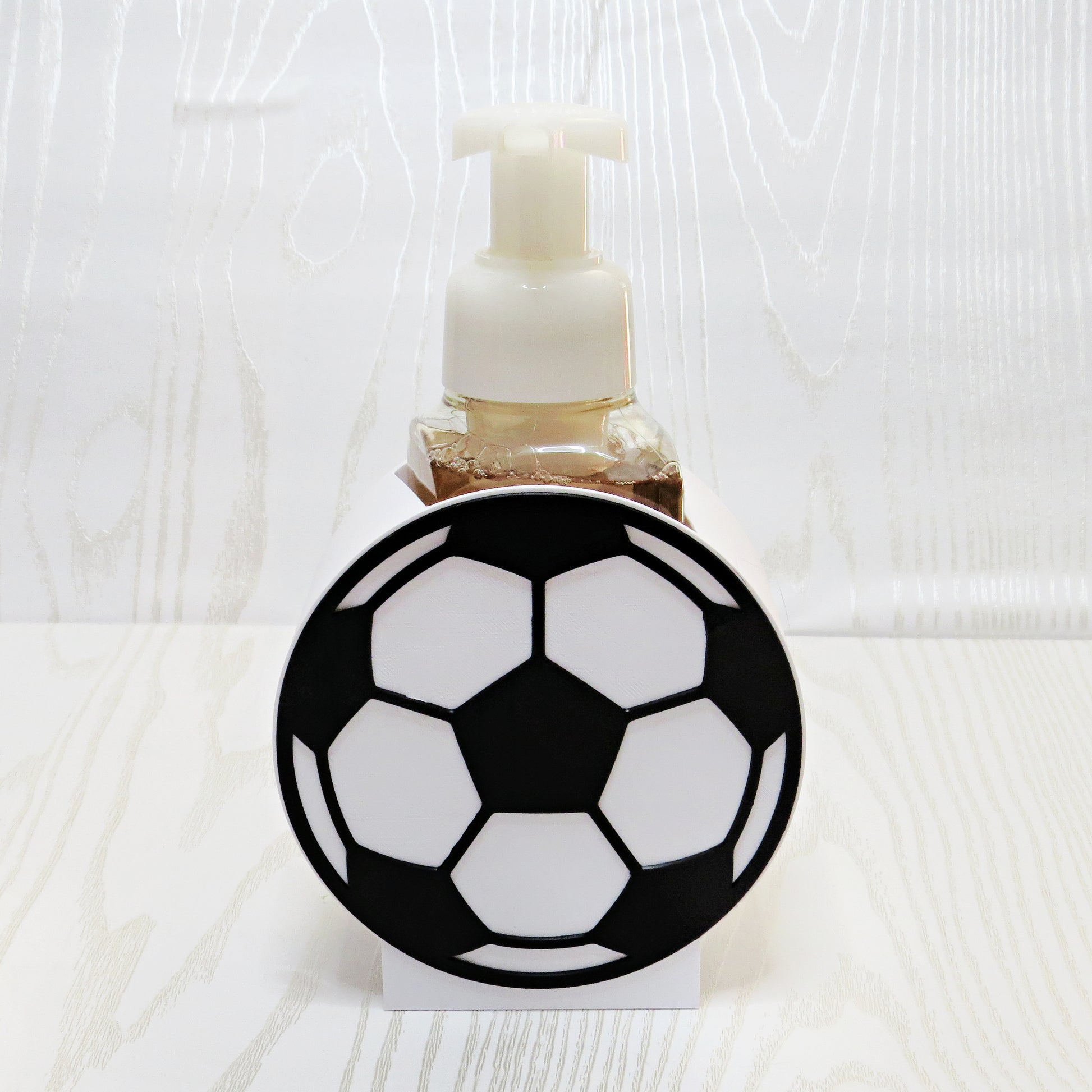 Soccer Ball Foaming Soap Holder - Sports Bathroom Decor for Kids & Soccer Fans - lifestyle with soap bottle inserted