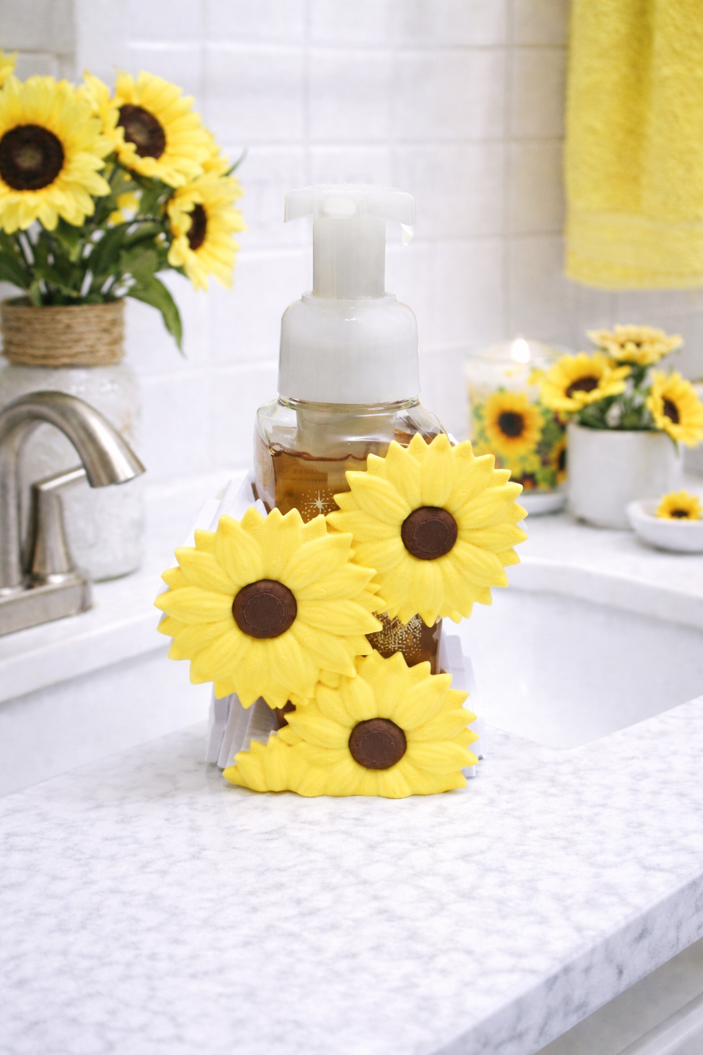 3D printed sunflower foaming soap holder with bright yellow flowers displayed around a foaming hand soap bottle on a white background